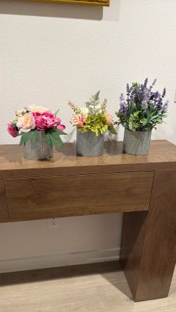 3 artificial flowers in pots
