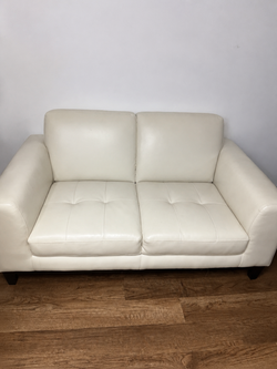 white loveseat with pillows included