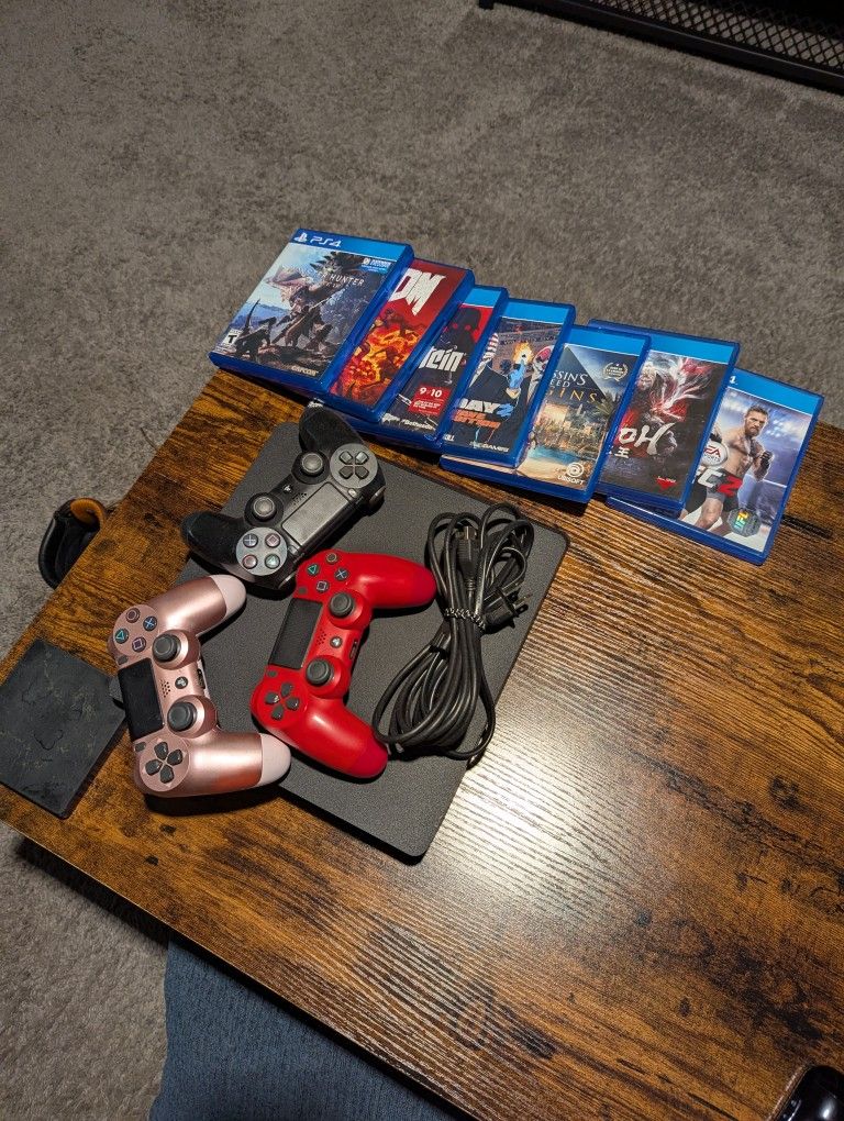 PlayStation 4 Slim with 3 Wireless Controllers and Games.