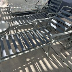 Two single lounge chairs with side table