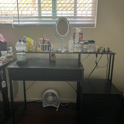 black computer desk with drawers, led lights, and power outlet