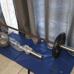Olympic Straight Bar 7ft.45lbs. Plus 2urethane 25lbs.olympic Plates Brand New, Commercial Grade. Total=95lbs. 