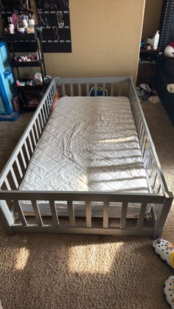 Toddler floor bed with mattress cover.