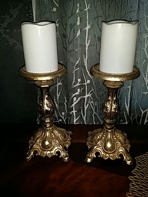 Antique candle holders and lamp.