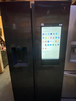 SAMSUNG SIDE BY SIDE REFRIGERATOR WITH A TABLET, DARK STAINLESS STEEL. ON SALE $650. PLUS FREE DELIVERY AND INSTALLATION.
