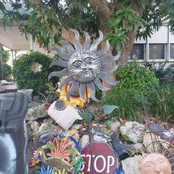 Tall metal sun face garden spinner