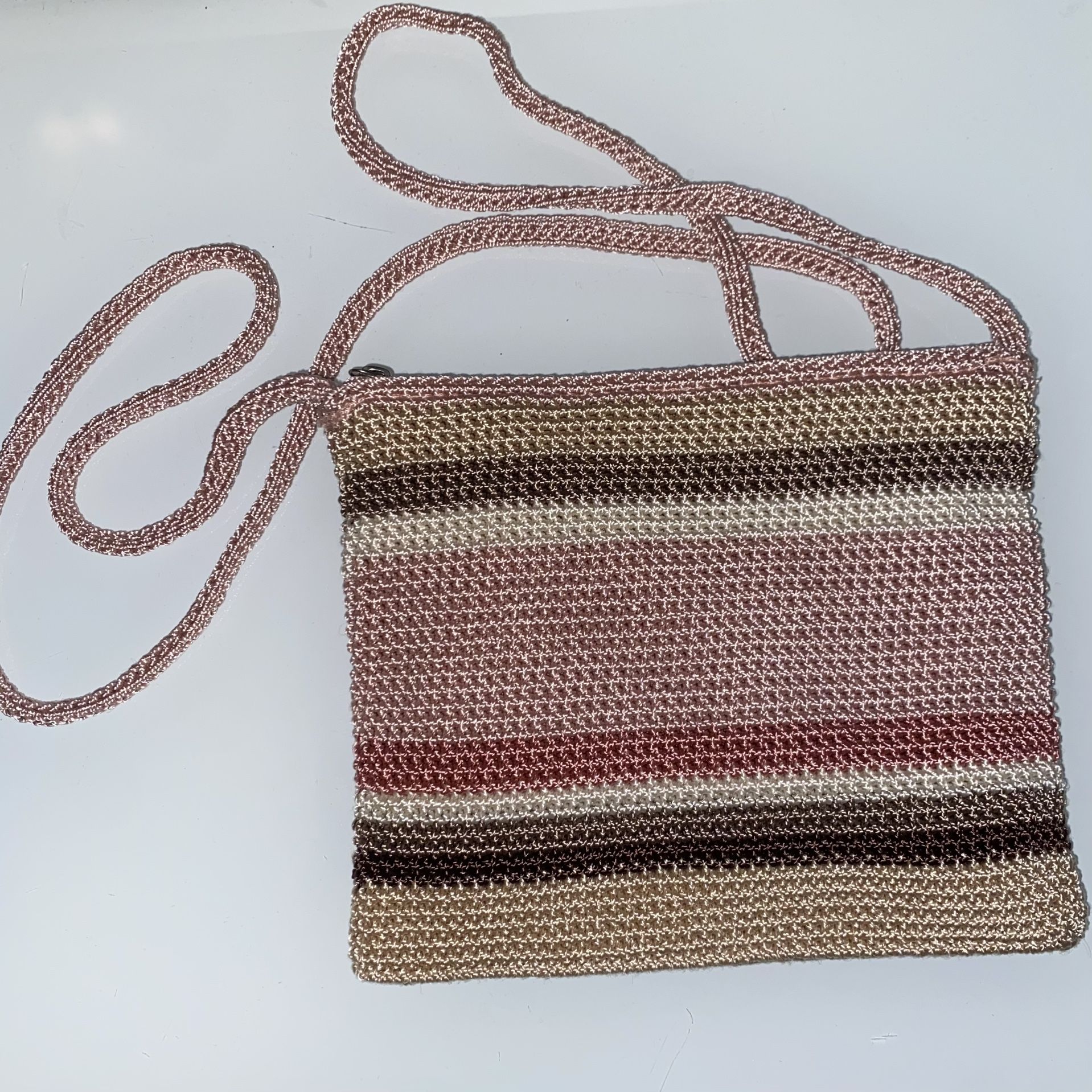 Small Purse Pouch Multicolor Pastel Pink and Brown Woven by The Sak with a small pocket inside with zipper closure. Material is really high quality