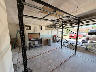 Heavy-duty industrial rack frame with sliding rails for workshop or garage