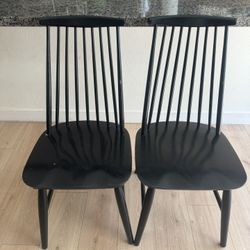 Two black farmhouse style dining chairs