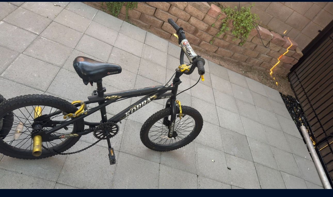 20” BMX freestyle bike with pegs – black/yellow, coaster brake, ready to ride.