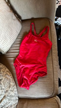 This red O'Neill branded one-piece swimsuit features a racerback design and prominent center chest logo.