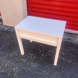 white nightstand or side table with an open shelf and a single drawer.