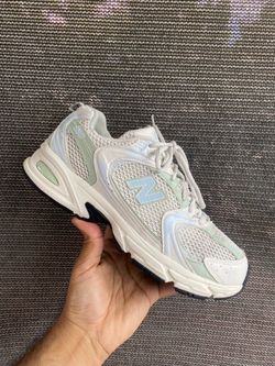 New Balance 530 trainers in white and mint green