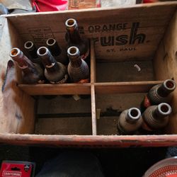 Antique bottles in wood create orange crush