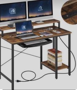 Rolanstar Computer Desk featuring a rustic brown finish, a built-in power outlet, a raised monitor stand