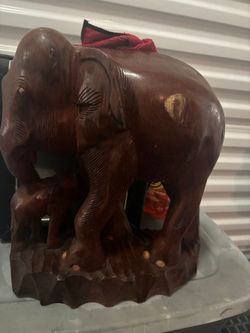 This is a hand-carved wooden elephant sculpture, likely made from teak or Indian rosewood, featuring a larger elephant with a baby elephant
