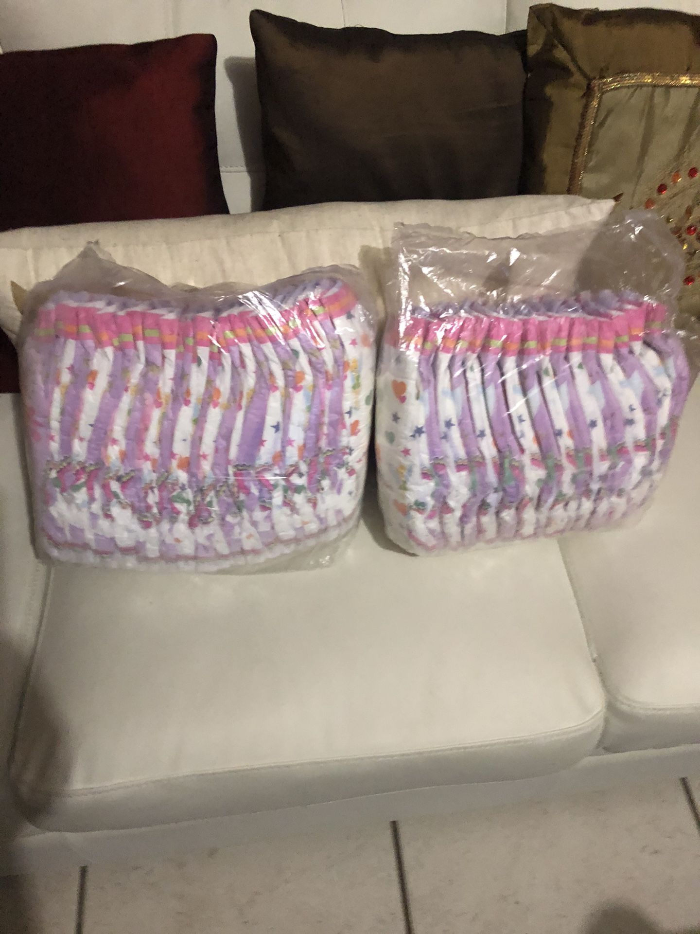New two packs diapers one big new close 1 bag open use a couple both packs $ 8 .00 firm