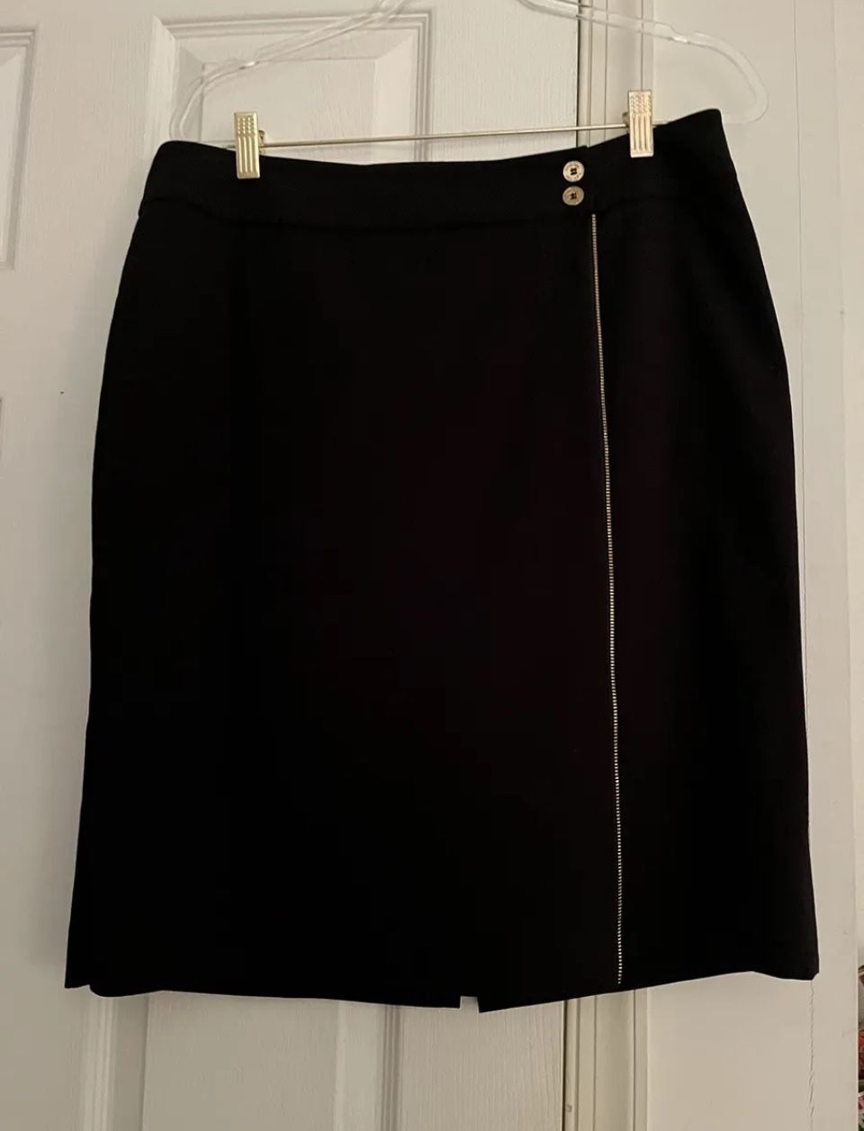 Calvin Klein black pencil skirt size 12. 64 % polyester, 31% rayon, 5% spandex. Gold color zipper from top to bottom accent on the front. 23.5” from