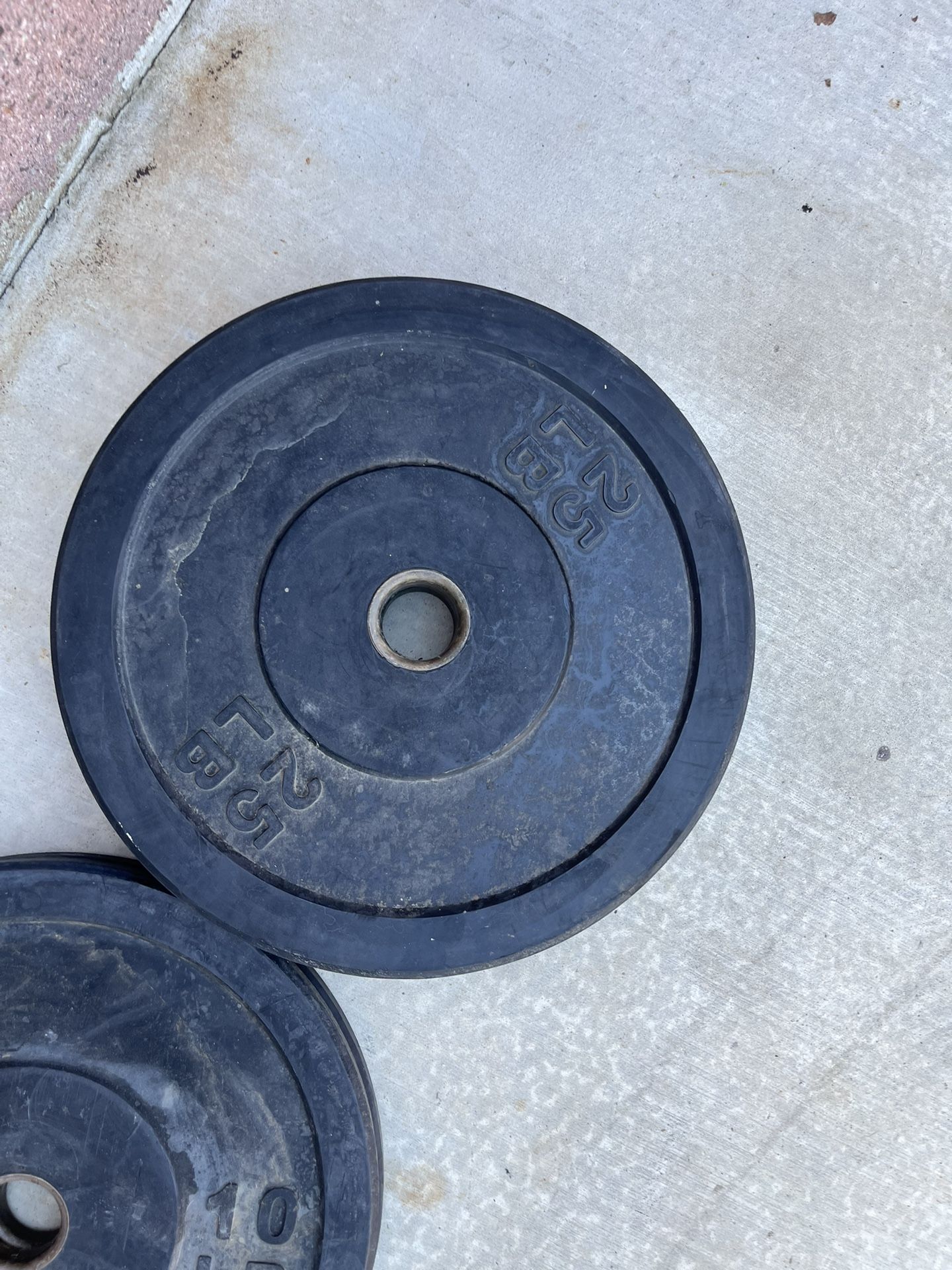 Rubber Olympic Weights 10s And 25s.