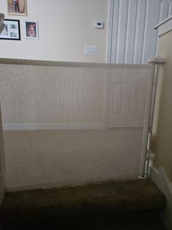 Retractable mesh safety gate