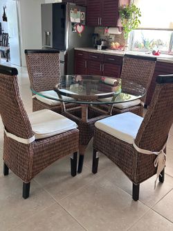 Modern Rattan dining set. Glass top table, 4 high back chairs. Excellent condition