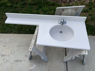 Bathroom countertop with ledge, sink and faucet
