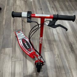 Razor E100 Kids Ride On 24V Motorized Battery Powered Electric Scooter Toy with up to 10 MPH Speed and 8 Inch Pneumatic Tires for Ages 8 Above, Red