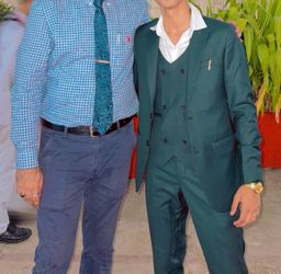 teal green three-piece suit designed for formal occasions