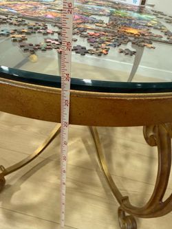Gold oval coffee table with glass top