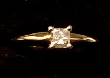 Princess cut diamond ring set in 14 karat gold Tiffany setting