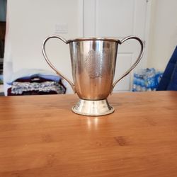 5 inch tall silver loving cup/ trophy cup, two prominent handles and a pedestal base, good condition 