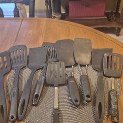 9 black plastic spatulas some with metal handles all in very good condition