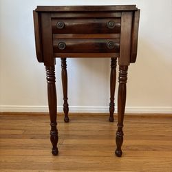 Antique mahogany drop-leaf side table with two drawers and turned legs