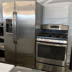 Stainless steel side-by-side refrigerator along with a stainless steel five burner gas stove