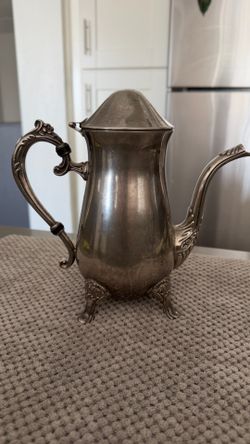 Vintage decorative coffee pot / teapot with ornate handles and feet.