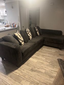 Large charcoal gray sectional couch