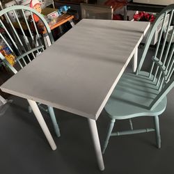Small Dining  table with two seafoam green chairs