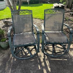 Pair of metal swivel rocking chairs