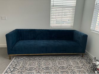 Like new blue velvet sofa with rug