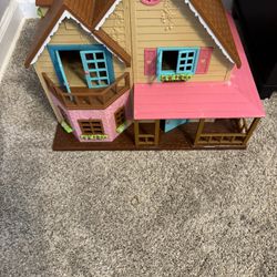 doll house with a few pieces of furniture 