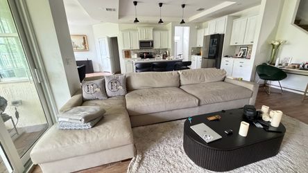 RH large, light beige L-shaped sectional sofa with a chaise lounge and accent pillows