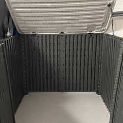 Durable resin outdoor storage shed is dark gray with a light gray lid. This YITAHOME.