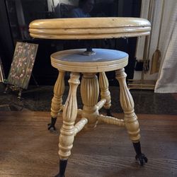 Antique piano stool with claw feet