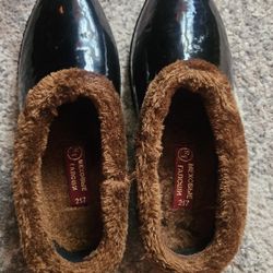 vintage-style black rubber overshoes or boots, often referred to as galoshes. 