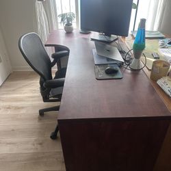 Dark wood desk with locked cabinet drawers