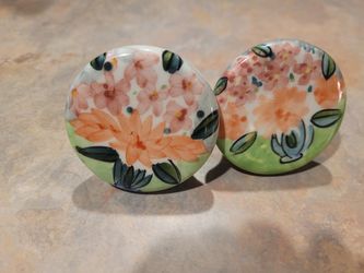 Decorative floral knobs for cabinets or drawers.