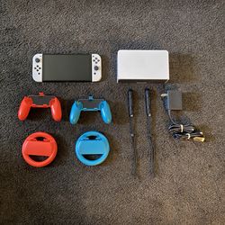 Nintendo Switch OLED and 2 Wheels and 2 Controller grips