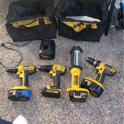 3 dewalt drills 4 battery’s dewalt light and charger and 2 bags 
