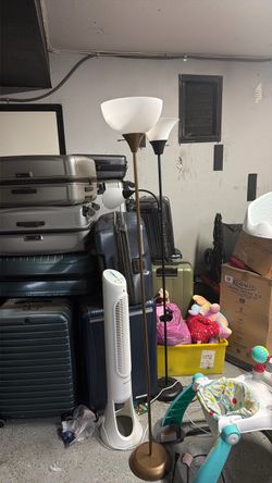 2 floor lamps a fan and yellow bin of kids stuff