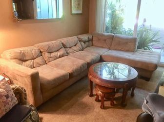 Large Tan Microfiber Couch / Sofa - 2 Sections Has one small hole that was sewn. Lite wear on one leg.  This couch is very easy to maintain and is ver